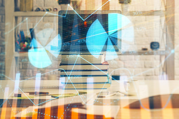 Financial graph colorful drawing and table with computer on background. Double exposure. Concept of international markets.