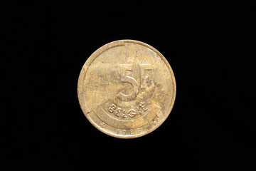 Old Belgian 5 francs coin from 1986, reverse. Isolated on black background