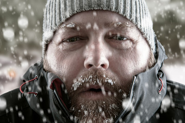 Man in snow storm close up - 293398774