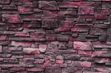 Decorative stone wall with a red tint