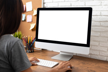 woman working empty screen computer on wood desk in home office. - obrazy, fototapety, plakaty