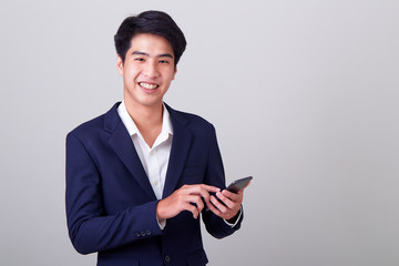 Young asian businessman using a smart phone - Powered by Adobe