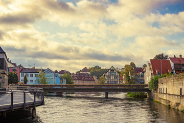 Traditional buildings and the Bischofsmühlbrücke bridge at the Regnitz river in the historic old town of Bamberg, a medieval city in Upper Franconia, Germany. Famous travel, tourism destination