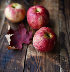striped apples of the new crop on a wooden table