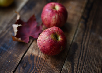 striped apples of the new crop on a wooden table