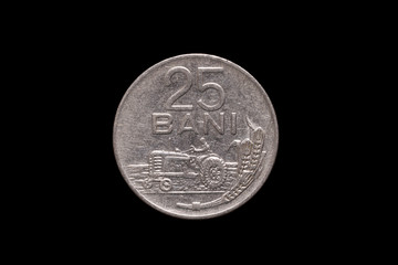 Socialist Republic of Romania old 25 Bani coin from 1966, reverse showing tractor driving left, wheat stalks to right. Isolated on black background