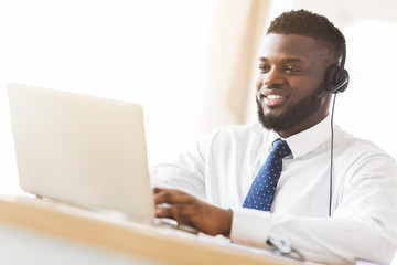 Smiling consultant chatting with clients online on laptop