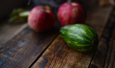 zucchini striped and red apples on the table