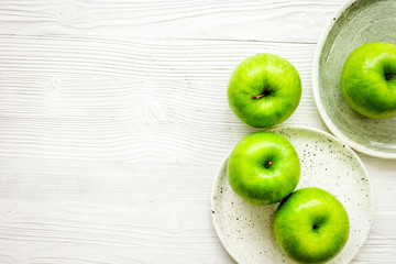 Healthy green food with apples on plates white background top view mock up