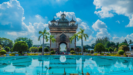 The beautiful Patuxai in Vientiane Laos in front of clear blue water