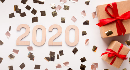 Wow 2020 New year concept with present boxes and gold confetti