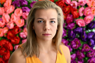 Close-up portrait of a cute caucasian blonde girl on a colored background