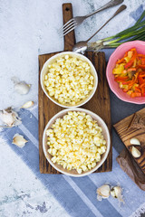 Cooked white corn kernels in bowl. Vegan lunch or vegetarian dinner.