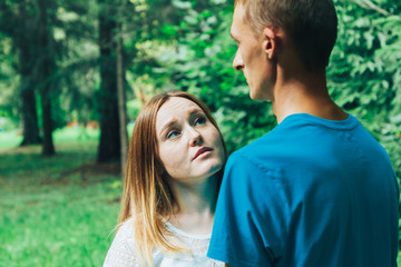 Fototapeta premium A guy and a girl are walking in the park