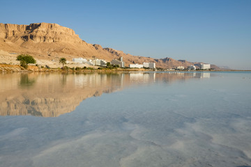 Dead Sea tourist resort of Ein Bokek reflected in the salt water