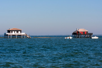 Fishermen houses huts of the basin of Arcachon pond on stilts in France at cap ferret Cabanes...