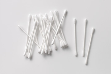 A pile of cotton swabs on a gray background. Space for text