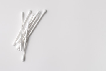 A pile of cotton swabs on a gray background. Space for text