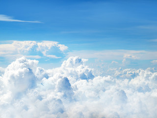 clear blue sky and white fluffy clouds, climate nature background, from the window of the plane.