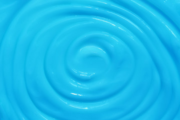 Blue cream swirl background. Beautiful texture of cosmetic cream.