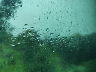 abstract background with drops of water, rain on glass, rain outside glass window, rain outside train window, rain texture, rain bokh