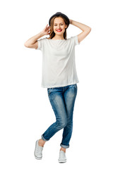 young cheerful girl in jeans, white t-shirt, sneakers and hat. isolated on white background