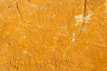 bright yellow sulfur wall texture ,  brimstone colored background , old rough ginger stone