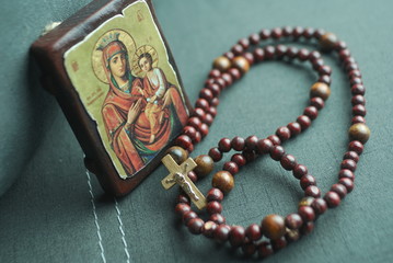 wooden rosary and icon of the Virgin Mary with the little Jesus