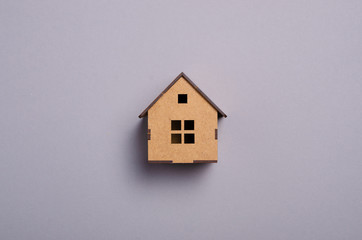 Obraz na płótnie Canvas Wooden house model on gray background, top view
