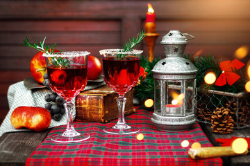 Christmas still life , two glass with red raspberry beverage decorated with rosemary , vintage old fashion style.