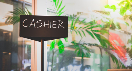Cashier sign on black background in restaurant