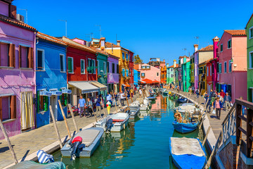 Street with colorful buildings and canal in Burano island, Venice, Italy. Architecture and landmarks of Venice, Venice postcard