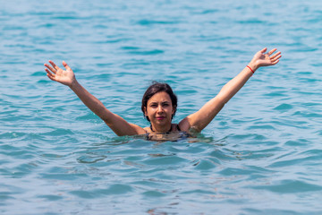 The girl bathes on the seashore