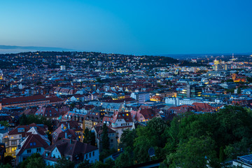 Germany, Aerial view over cityscape and skyline of big city stuttgart houses in basin after sunset, view from above