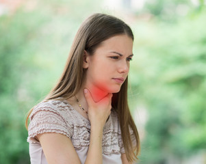 Young woman having sore throat