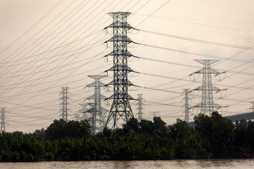 Fototapeta premium massive towers carrying high tension and high voltage power lines in rural Vietnam