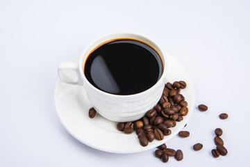 Cup Of Black Coffee With Roasted Coffee Beans On Grey Background