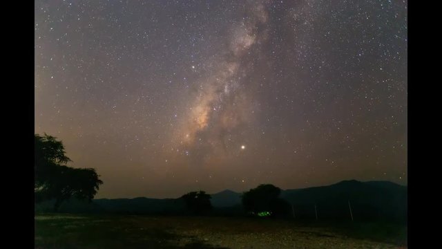 Timelape of the milkyway galaxy over the mountain with star light at Tark province , Thailand.