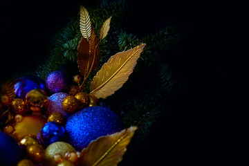 Blue and golden Christmas balls on a christmas tree closeup view in a low key with a copy space - 293417133