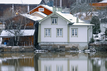 Old historic Porvoo, Finland with Traditional Scandinavian rural red wooden houses under white snow. Snowing - 293417162