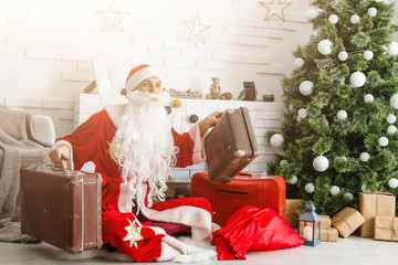 Obraz premium Christmas Santa Claus with suitcases at his home. Christmas, New Year.