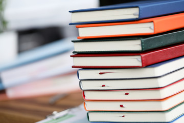 Lot of book li on the table against study room background. Fast online education concept. Distance remote knowledge control.