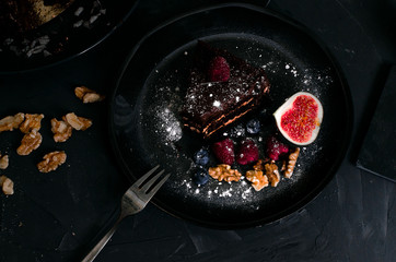chocolate cake with fresh berries and nuts