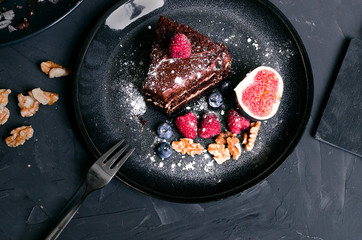chocolate cake with fresh berries and nuts