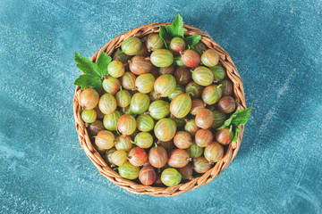 Fresh gooseberries in wicker basket