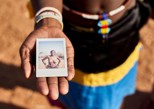 Mudimba tribe woman showing picture of herself
