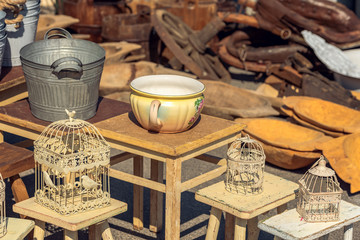 Market stall with objects and old things at the weekend flea market in the city center. Concept. Old objects for sale