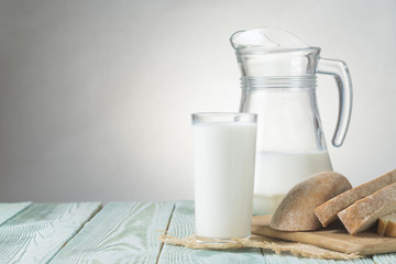 Still life with a view of a glass of milk and fresh bread