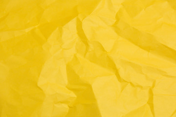 yellow crumpled sheet of colored paper texture