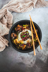 General Tso's Chicken with steamed rice and chopsticks 
